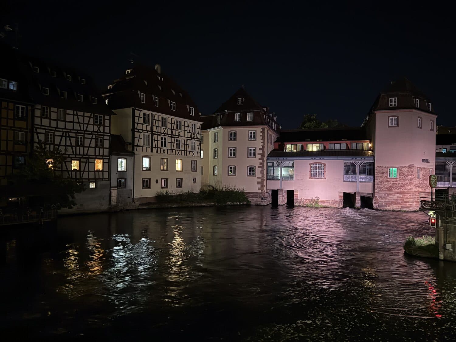 Strasbourg at night, lit windows over the water